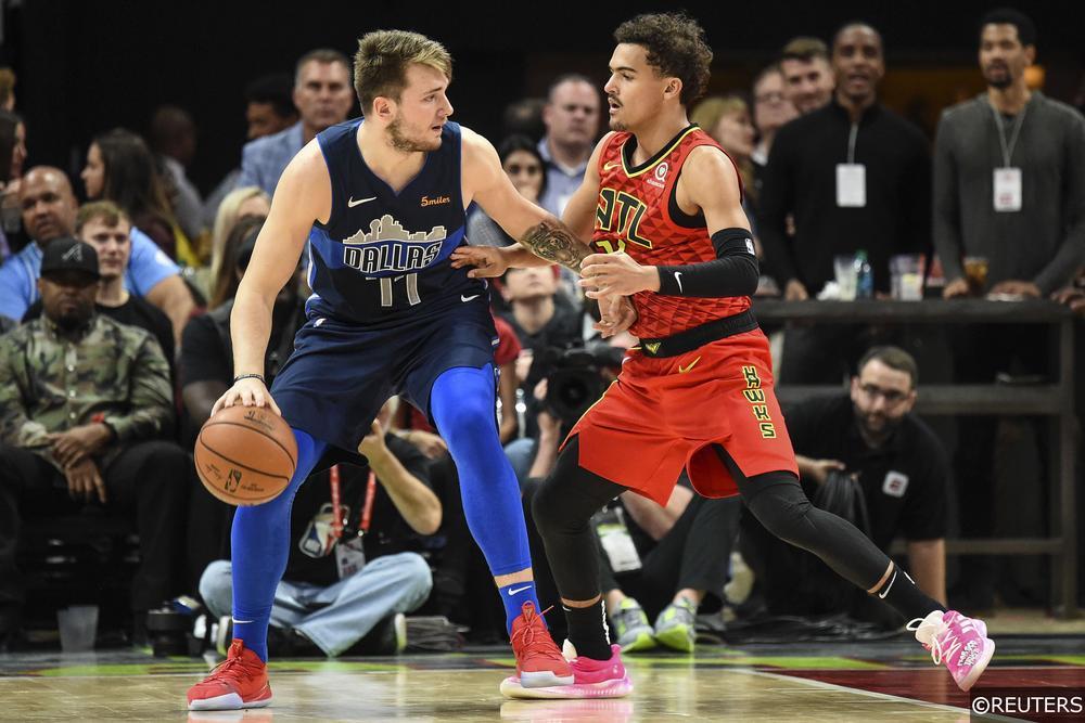 Trae Young guarding Luka Doncic during a Hawks vs. Mavericks game.