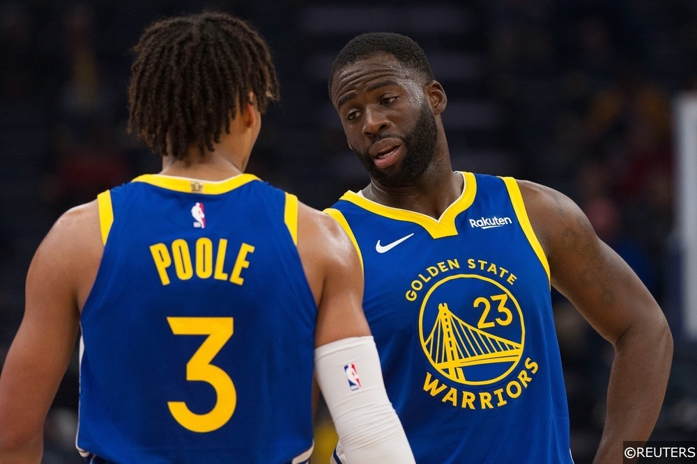 Draymond Green and Jordan Poole of the Golden State Warriors talk during a game.