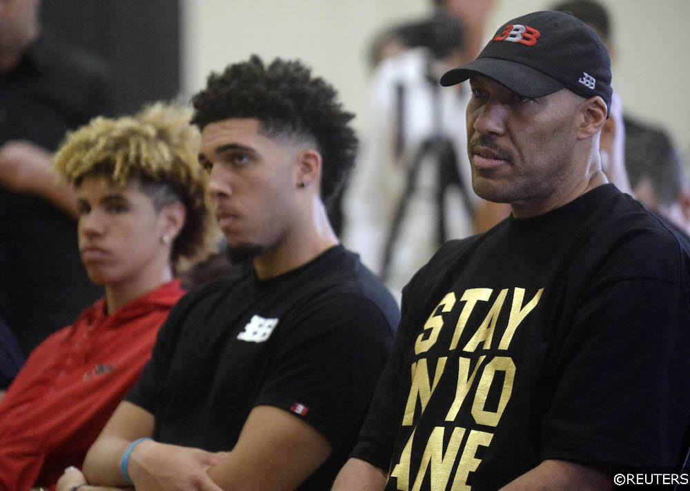 LaMelo, LiAngelo, and LaVar Ball watch a press conference.