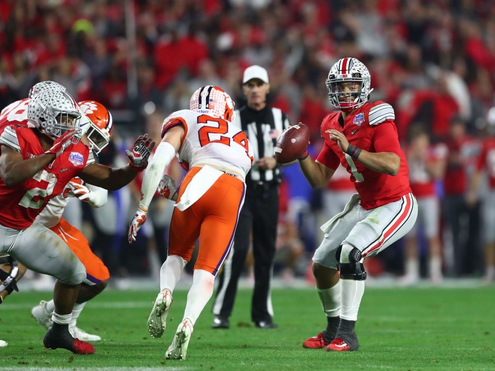 Justin Fields of the Ohio State Buckeyes prepares to pass against the Clemson Tigers.