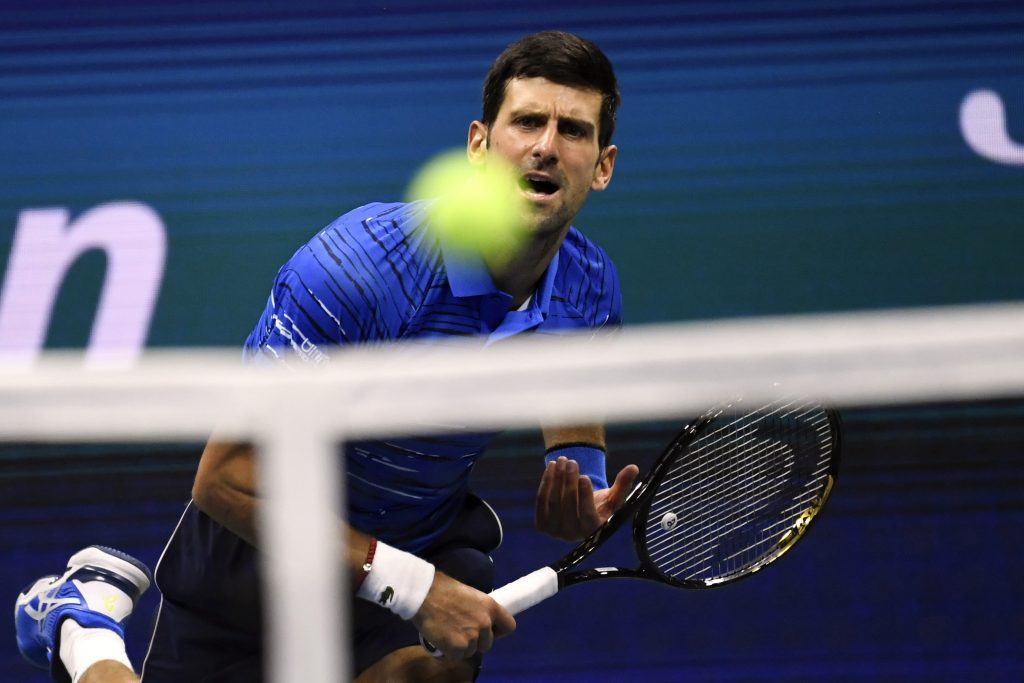 Novak Djokovic hits a serve at the 2019 U.S. Open.