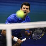 Novak Djokovic hits a serve at the 2019 U.S. Open.
