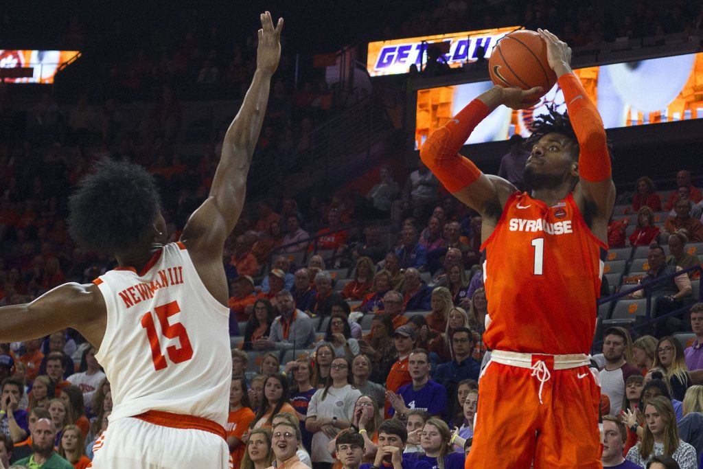 Syracuse's Quincy Guerrier looks to shoot over Clemson's John Newman