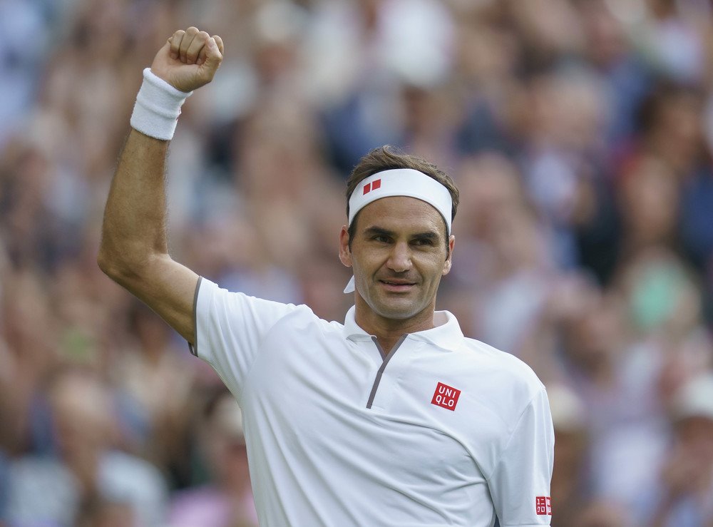 Roger Federer fist pumps after beating Rafael Nadal at Wimbledon.