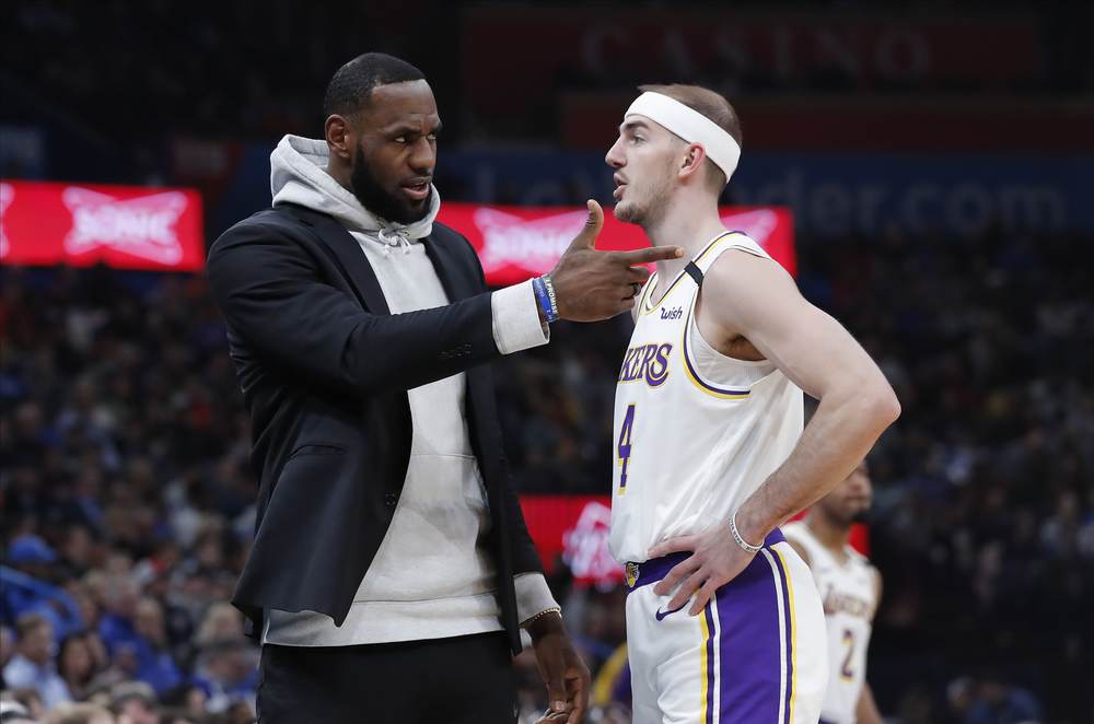 LeBron James talks with Los Angeles Lakers teammate Alex Caruso.