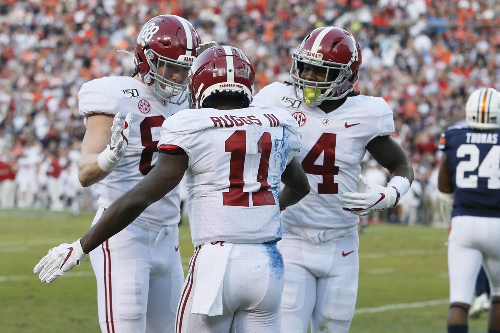 Henry Ruggs III celebrates a big play with Alabama teammates.