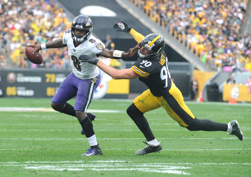 Baltimore Ravens quarterback Lamar Jackson (8) pushes away Pittsburgh Steelers linebacker T.J. Watt (90) during the first quarter at Heinz Field.