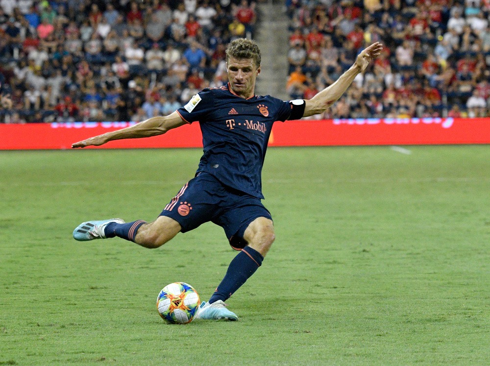 Bundesliga soccer player Thomas Muller kicking a soccer ball