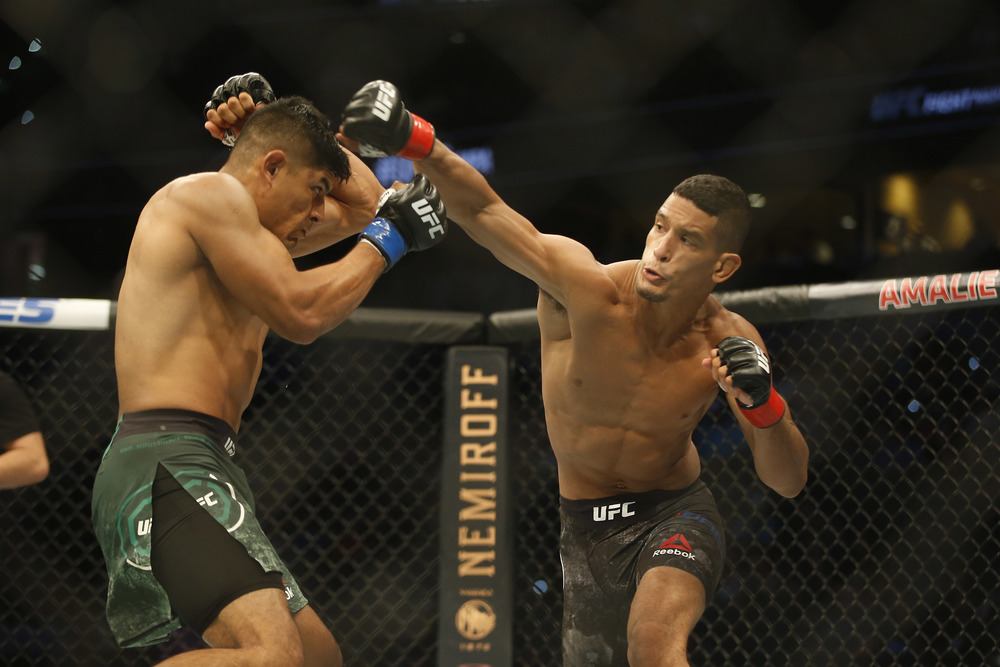 Miguel Baeza (red gloves) throwing a punch in his fight at UFC Fight Night Tampa