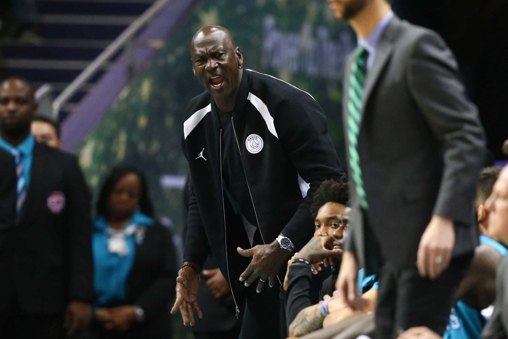 Charlotte Hornets owner Michael Jordan reacts on the sideline.