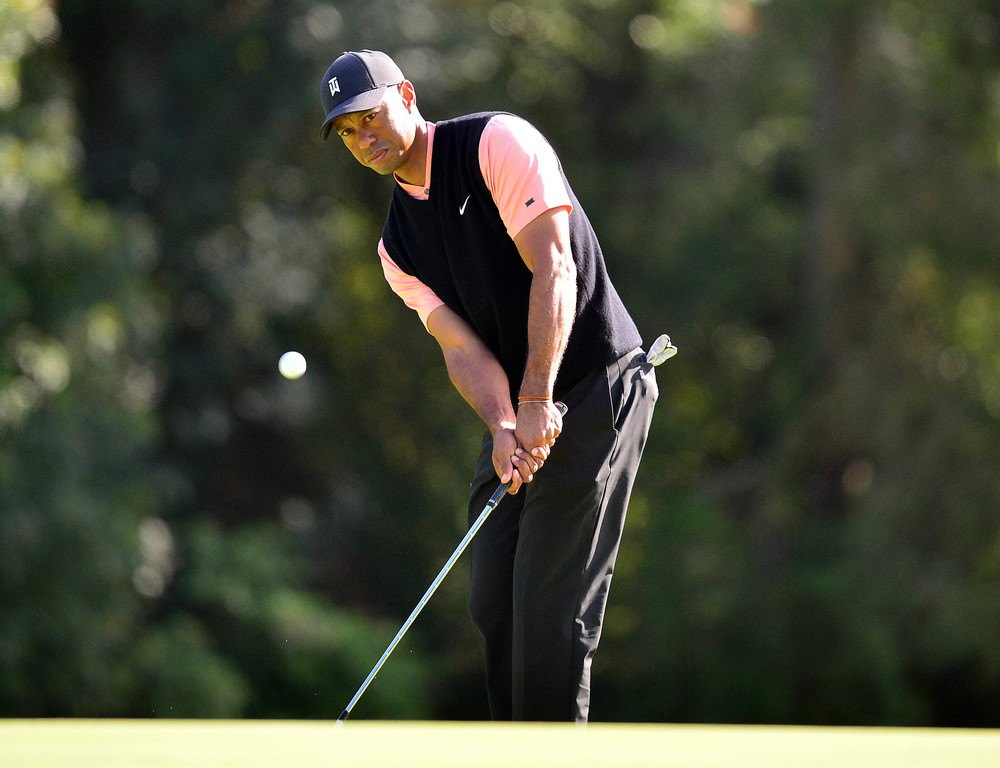 Tiger Woods hits a chip at the Genesis Invitational.