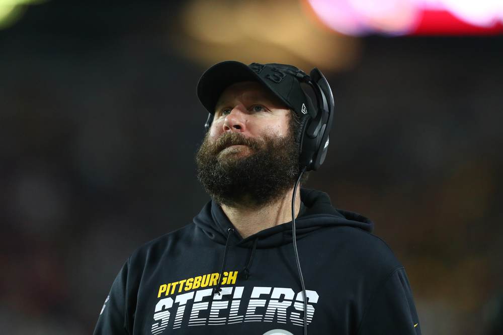 An injured Ben Roethlisberger roams the sidelines during a Pittsburgh Steelers game.