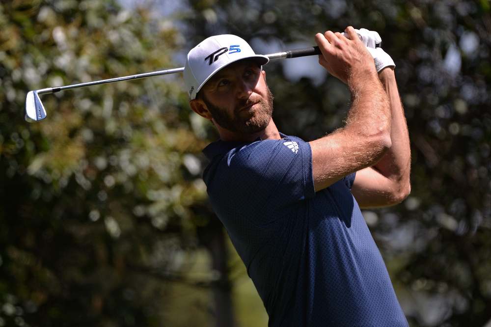 Dustin Johnson hits a shot at the 2020 WGC-Mexico.