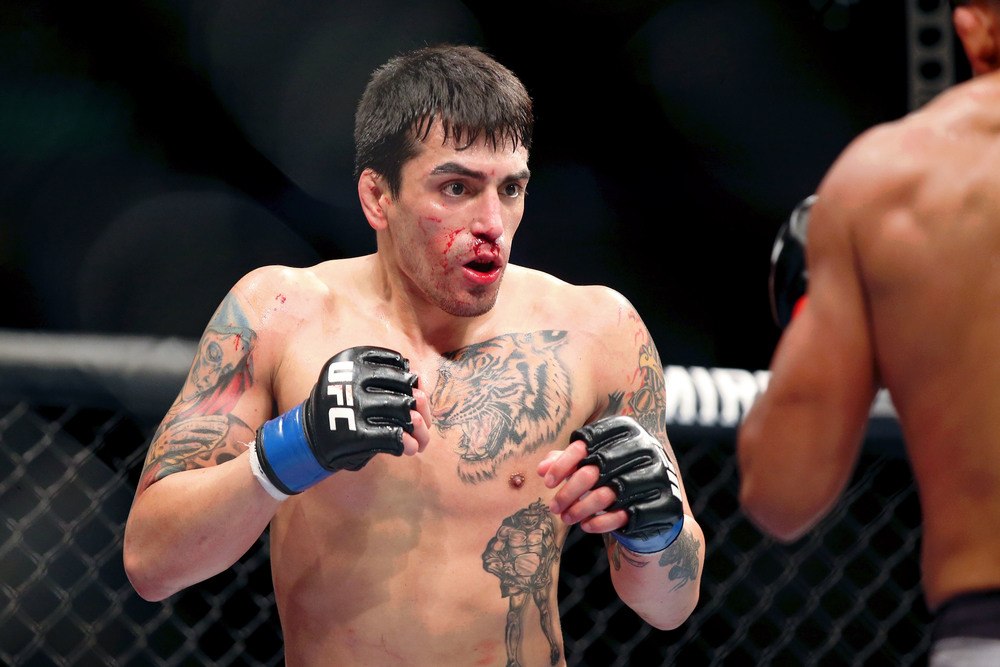 Enrique Barzola (red gloves) fights Kevin Aguilar (blue gloves) during UFC Fight Night at Wells Fargo Arena.