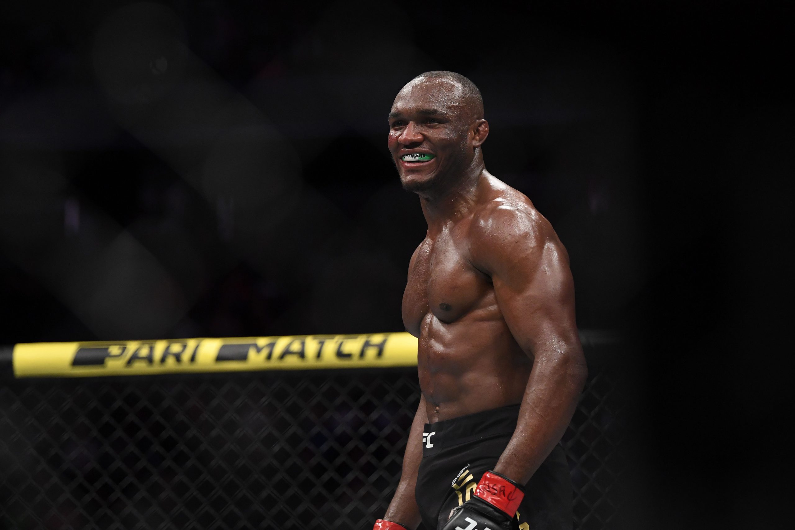 Kamaru Usman (red gloves) reacts after defeating Colby Covington
