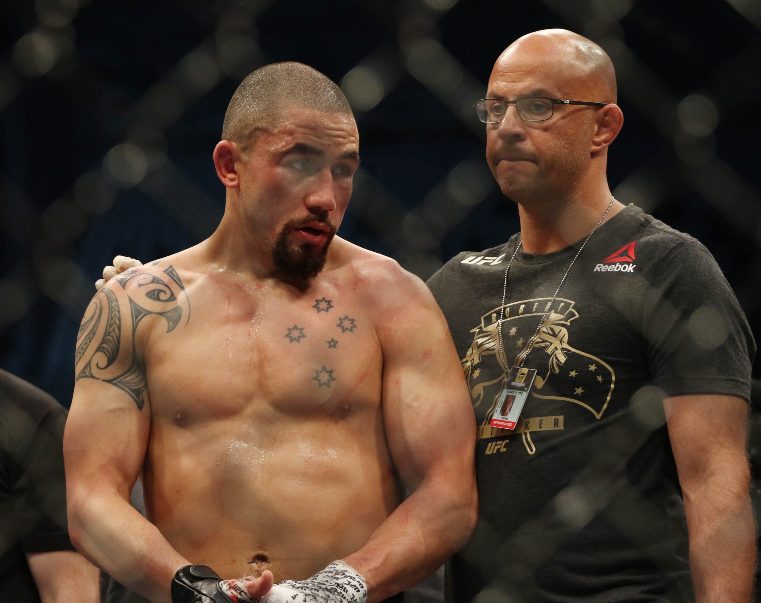 Oct 5, 2019; Melbourne, AUSTRALIA; Robert Whittaker (red gloves) reacts after losing to Israel Adesanya (blue gloves) during UFC 243 at Marvel Stadium.
