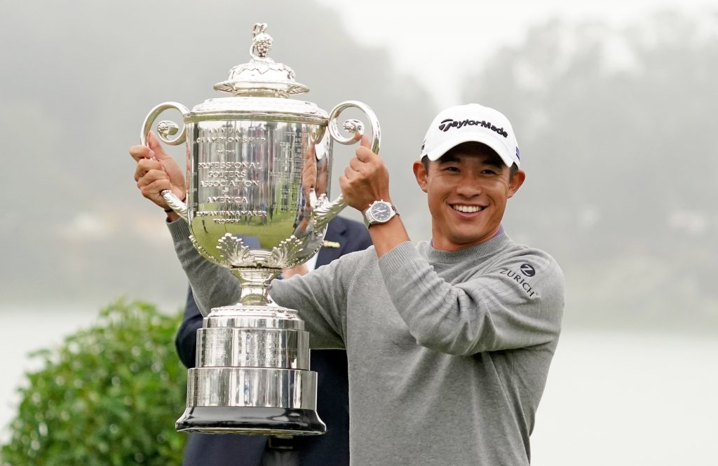 Collin Morikawa lifts the PGA Championship trophy.