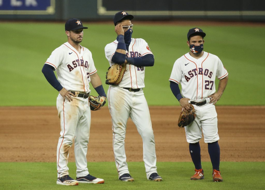 Houston Astros third baseman Alex Bregman (2) and first baseman Yuli Gurriel (10) and second baseman Jose Altuve (27) react during the tenth inning against the San Francisco