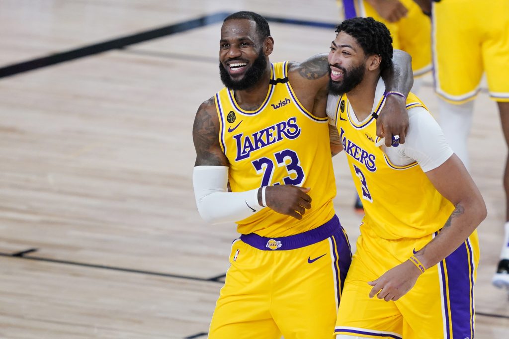 LeBron James (23) and Anthony Davis (3) celebrate after defeating the Denver Nuggets