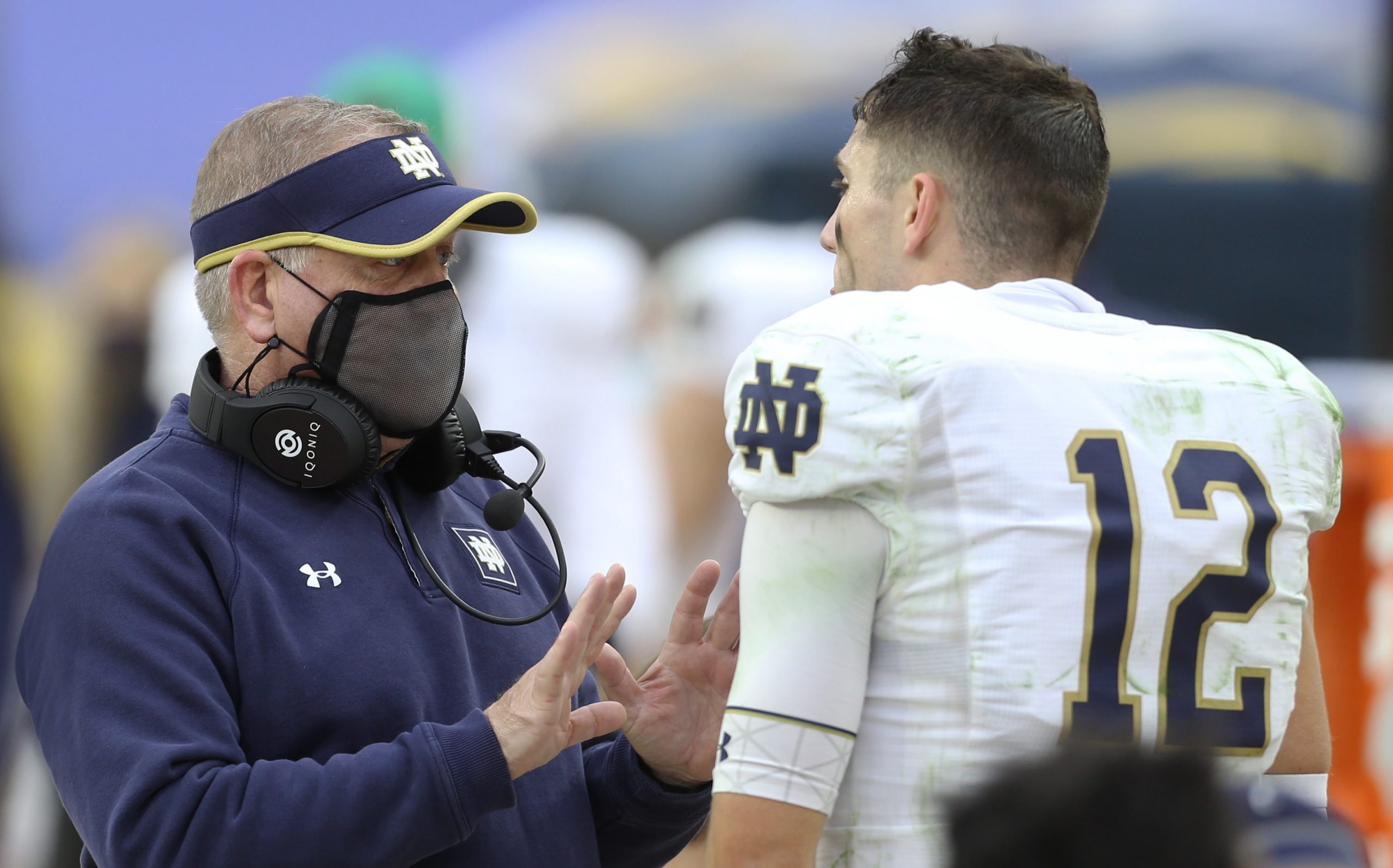 Notre Dame Fighting Irish quarterback Ian Book talks to head coach Brian Kelly during team's win over Pittsburgh