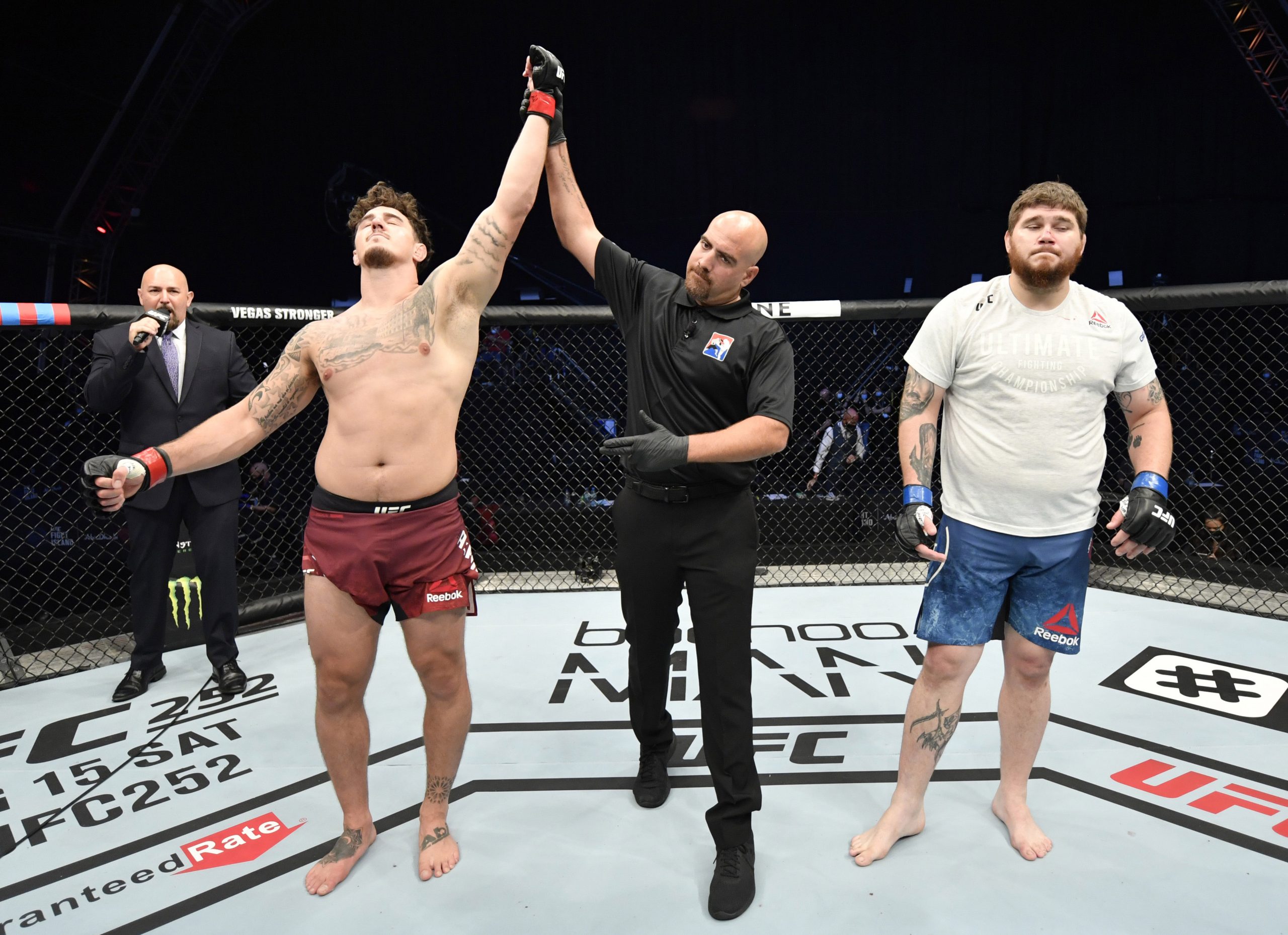 July 26, 2020; Abu Dhabi, UAE; Tom Aspinall (red gloves) of England celebrates after his victory over Jake Collier (blue gloves) in their heavyweight fight during the UFC Fight Night event inside Flash Forum on UFC Fight Island.