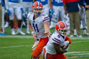 Kyle Trask of the Florida Gators hands the ball off.