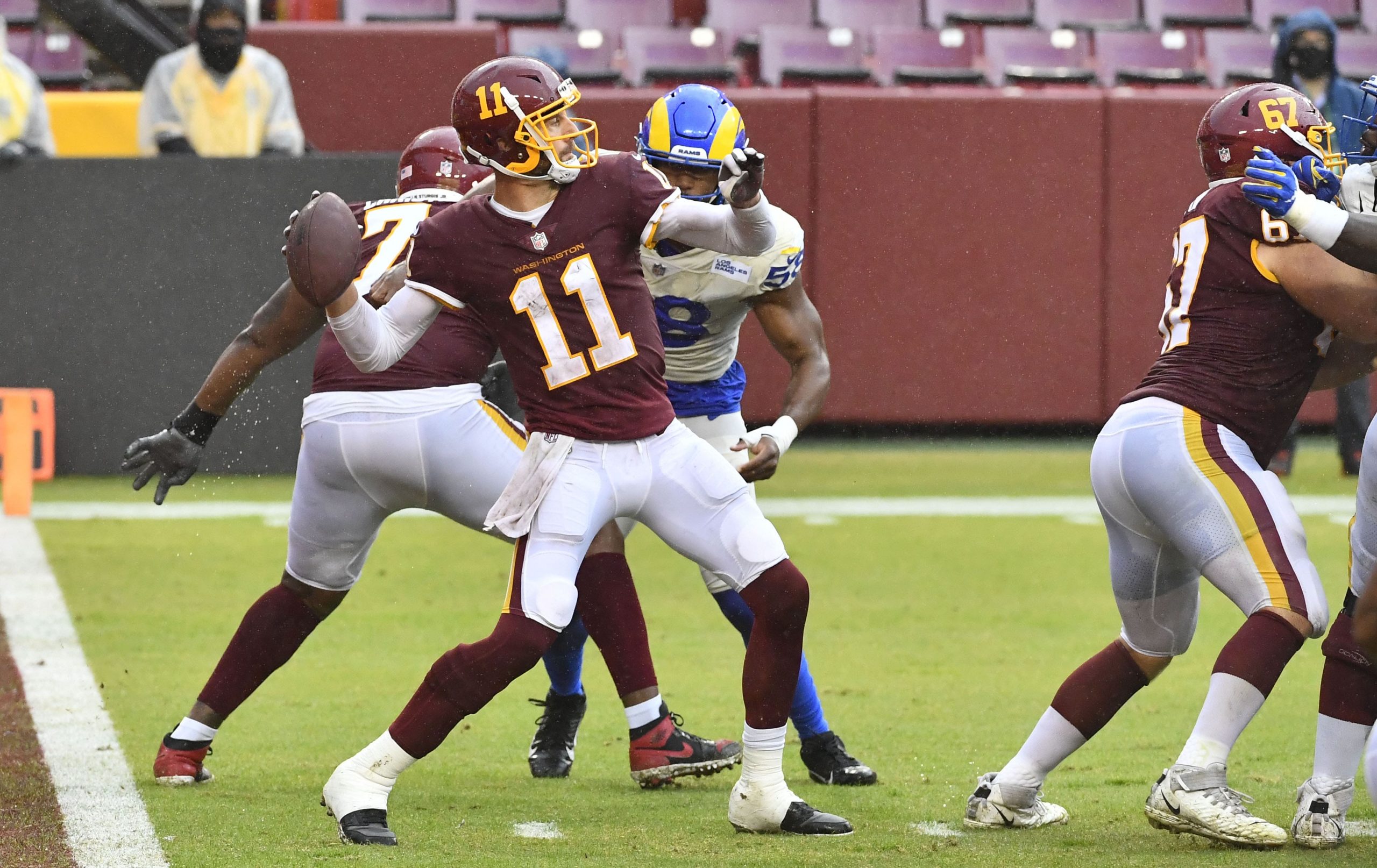 Washington Football Team quarterback Alex Smith attempts a pass against the Los Angeles Rams during the second half at FedExField.