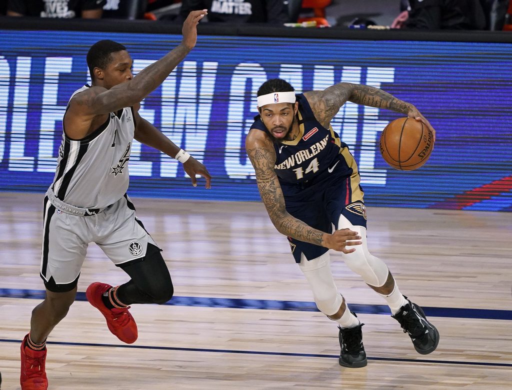 New Orleans Pelicans Forward Brandon Ingram dribbles past defender in game against San Antonio Spurs