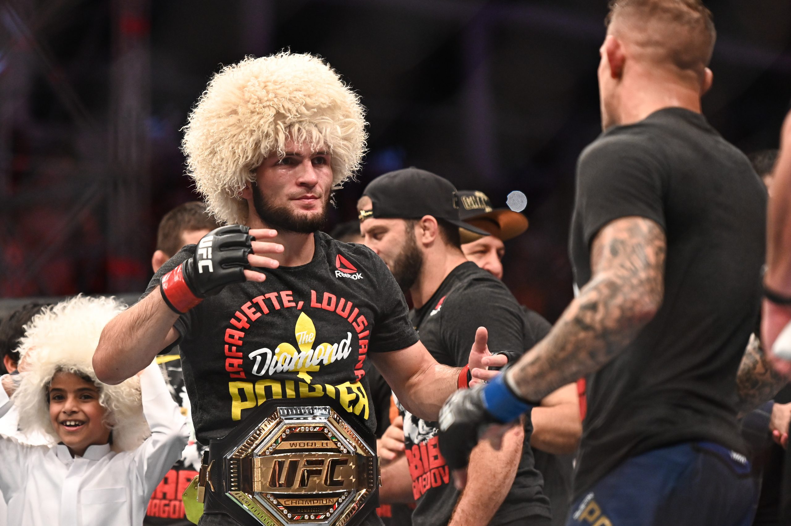 Sep 7, 2019; Abu Dhabi, UAE; Khabib Nurmagomedov (red gloves) greets Dustin Poirier (blue gloves) during UFC 242 at The Arena.