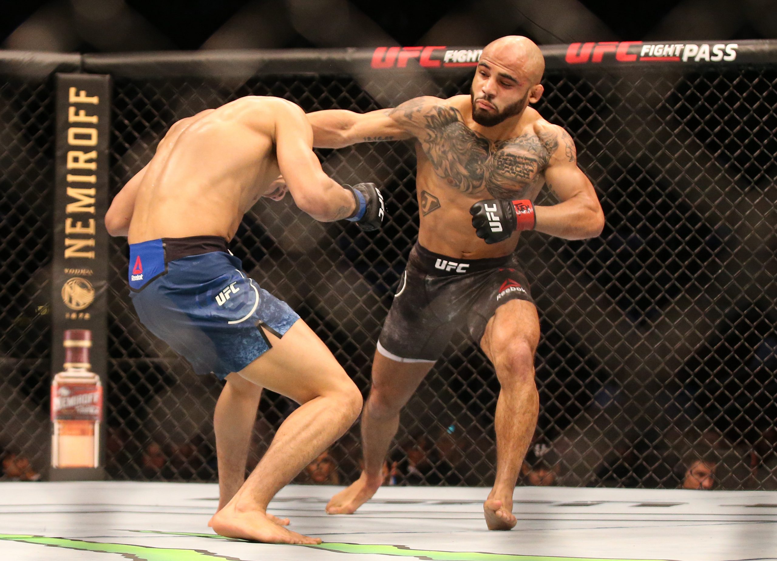 Feb 8, 2020; Houston, Texas, USA; Miles Johns (red gloves) fights Mario Bautista (blue gloves) during UFC 247 at Toyota Center.