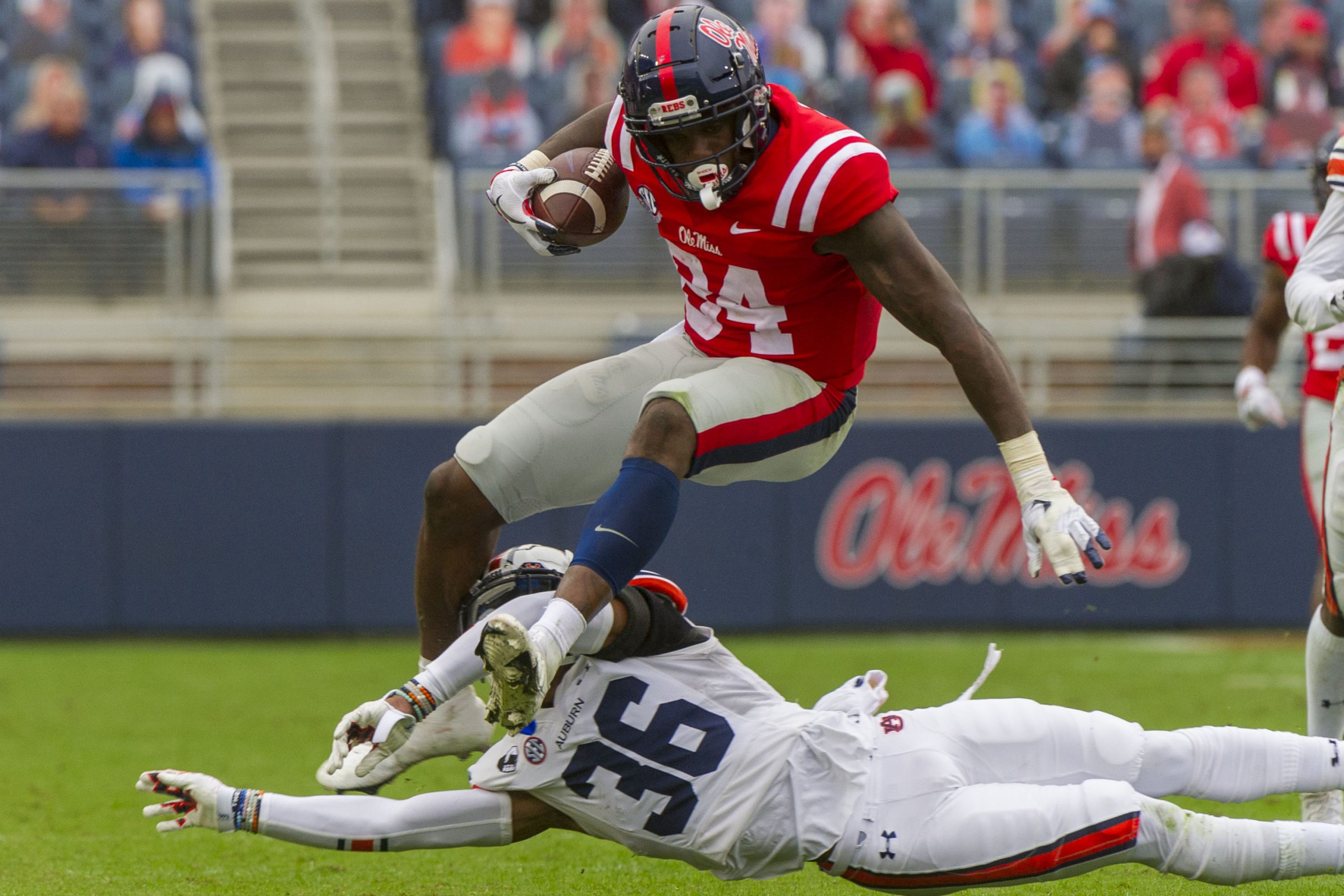 Oct 24, 2020; Oxford, Mississippi, USA; Mississippi Rebels tight end Kenny Yeboah (84) jumps over Auburn Tigers defensive back Jaylin Simpson (36) during the second half at Vaught-Hemingway Stadium.