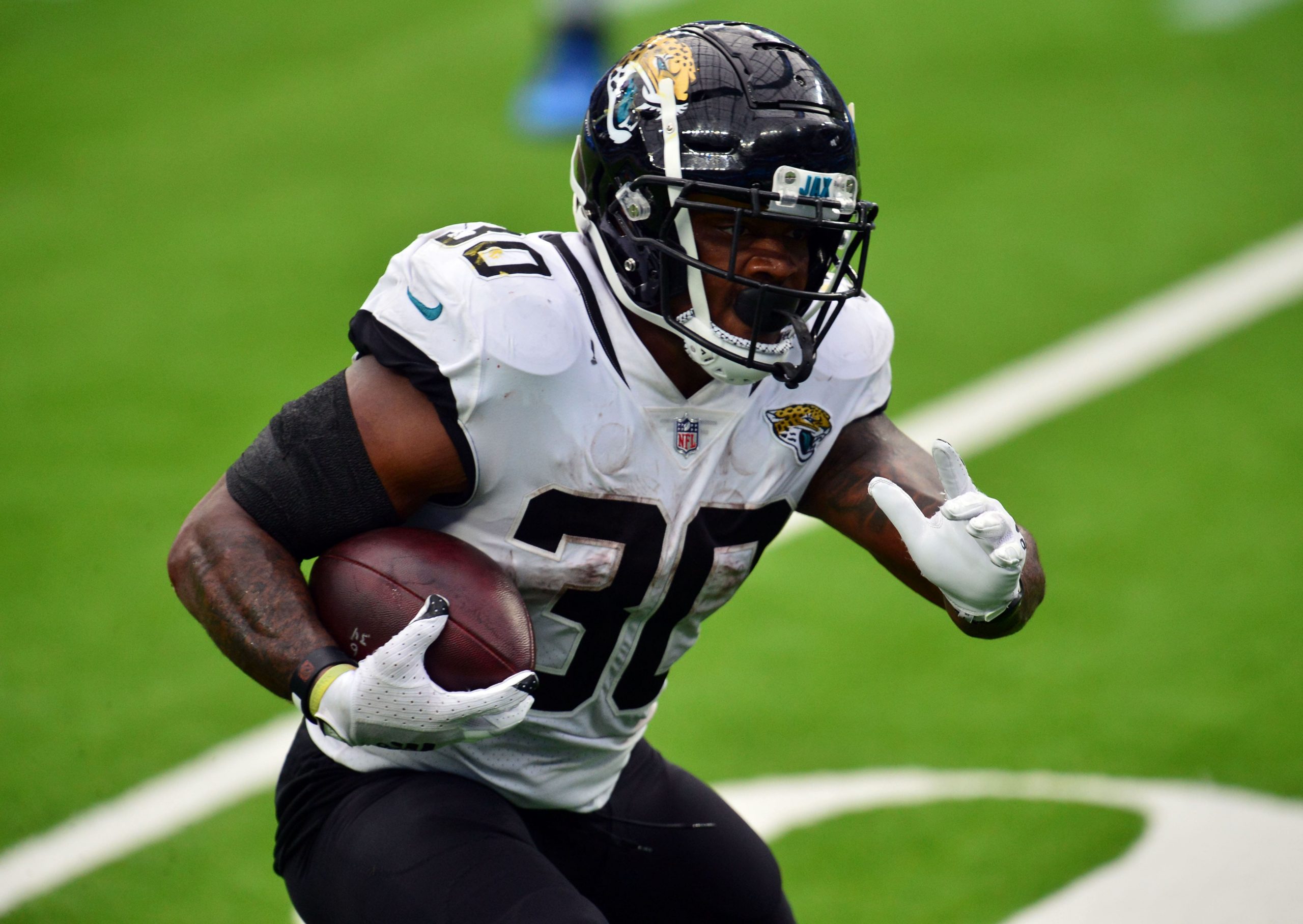 Jacksonville Jaguars running back James Robinson (30) runs the ball against the Los Angeles Chargers during the first half at SoFi Stadium.