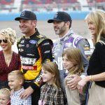 Clint Bowyer and his family take a picture with Jimmie Johnson (R) and his family as the two set to retire after the Season Finale 500 at Phoenix Raceway in Phoenix, Ariz. on Nov. 8, 2020.