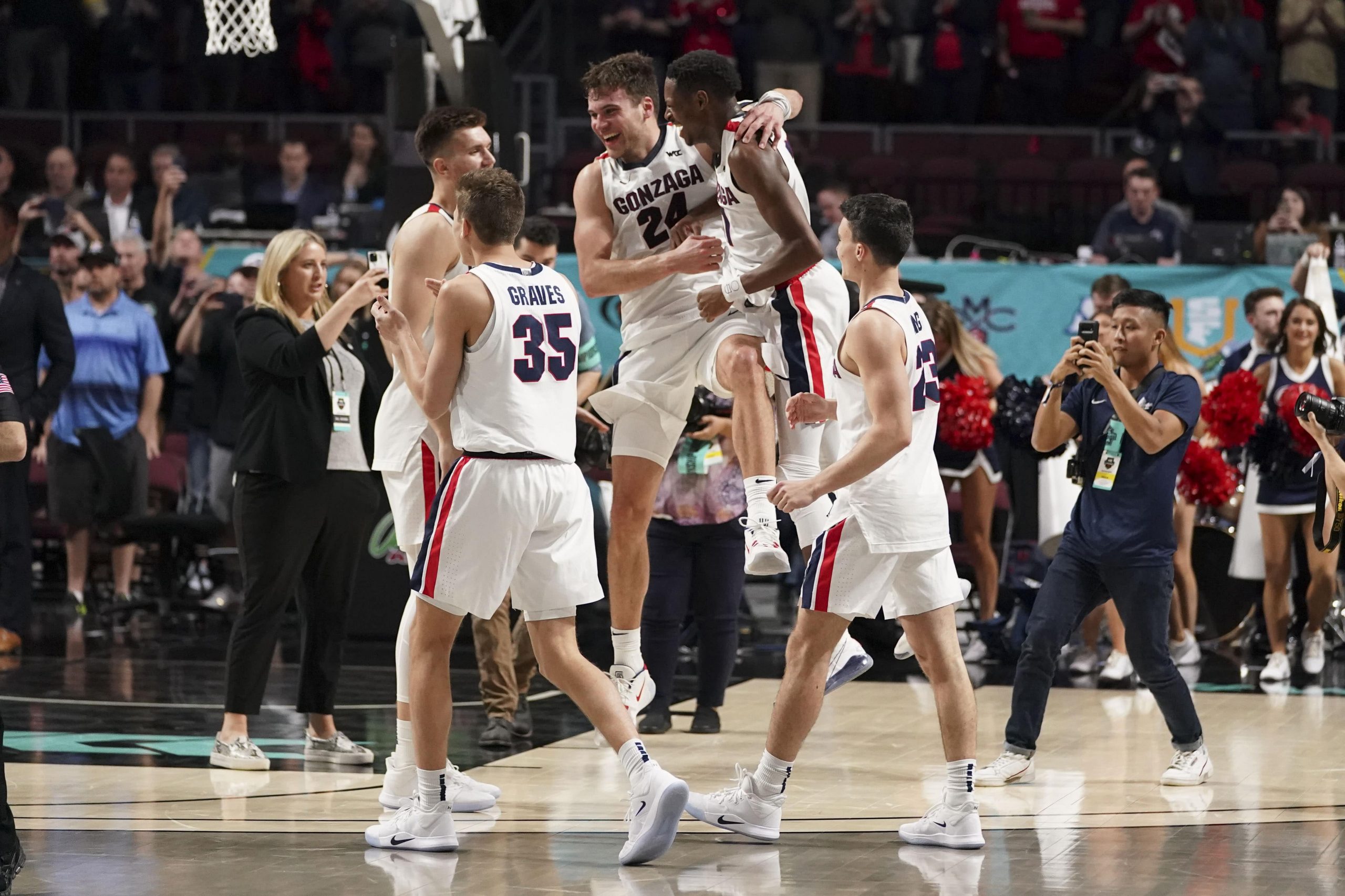 Gonzaga Bulldogs basketball players celebrate after beating the Saint Mary's Gaels in the WCC Championship Game