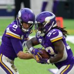 Minnesota Vikings quarterback Kirk Cousins (8) hands the ball off to running back Dalvin Cook (33) against the Detroit Lions in the third quarter at U.S. Bank Stadium.