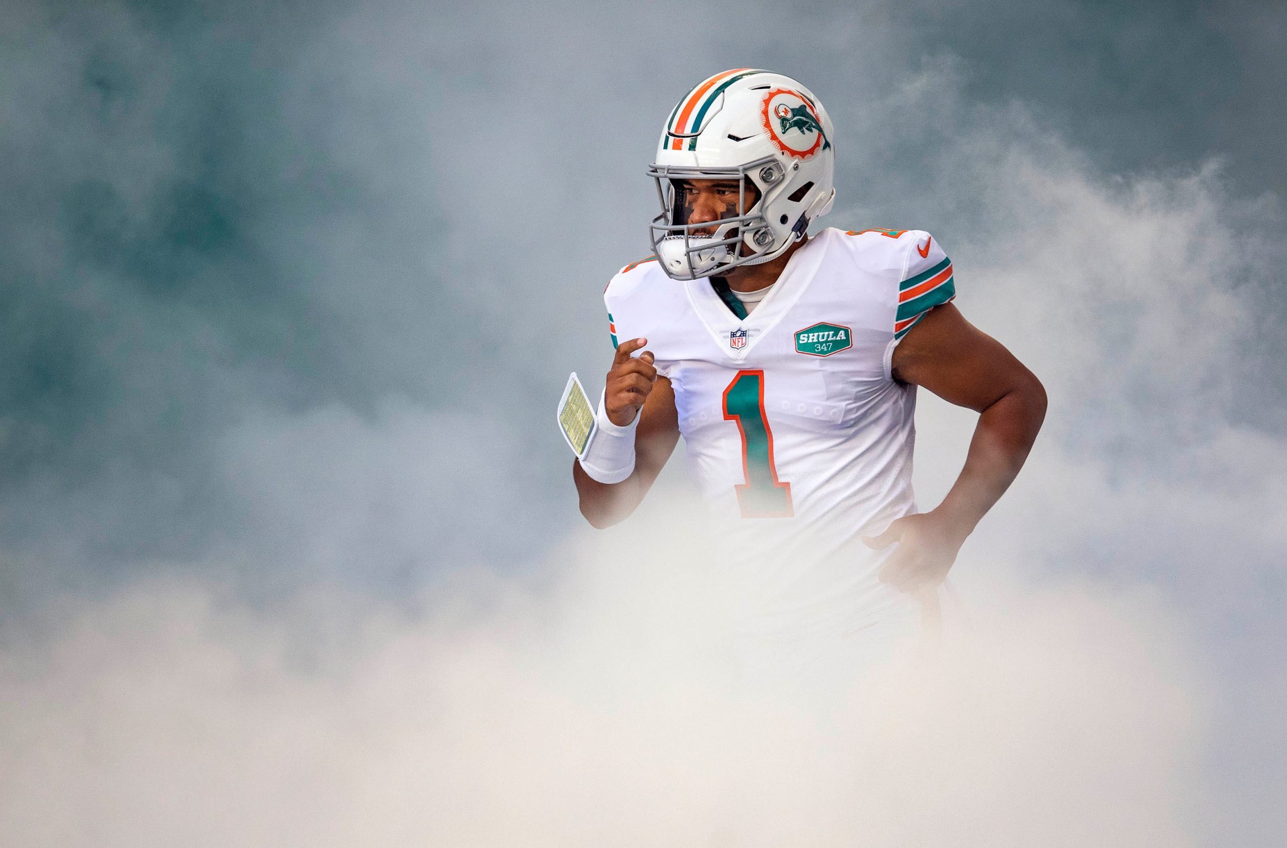 Miami Dolphins quarter back Tua Tagovailoa runs onto field for game against the Chargers