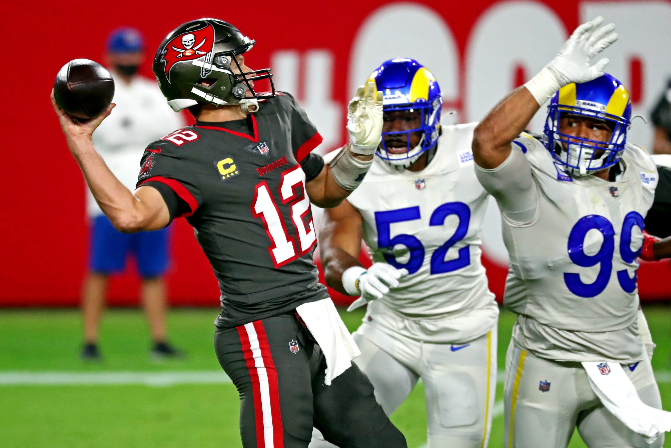 Tampa Bay Buccaneers quarterback Tom Brady is chased by Los Angeles Rams defensive tackle Aaron Donald