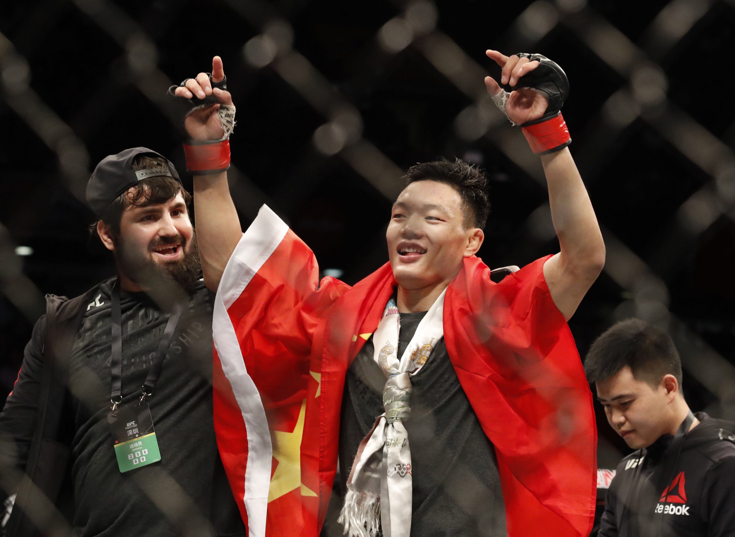 Aug 31, 2019; Shenzhen, China; Su Muaderji (red gloves) defeats Andre Soukhamathath (blue gloves) during UFC Fight Night at Shenzhen Universiade Sports Centre.