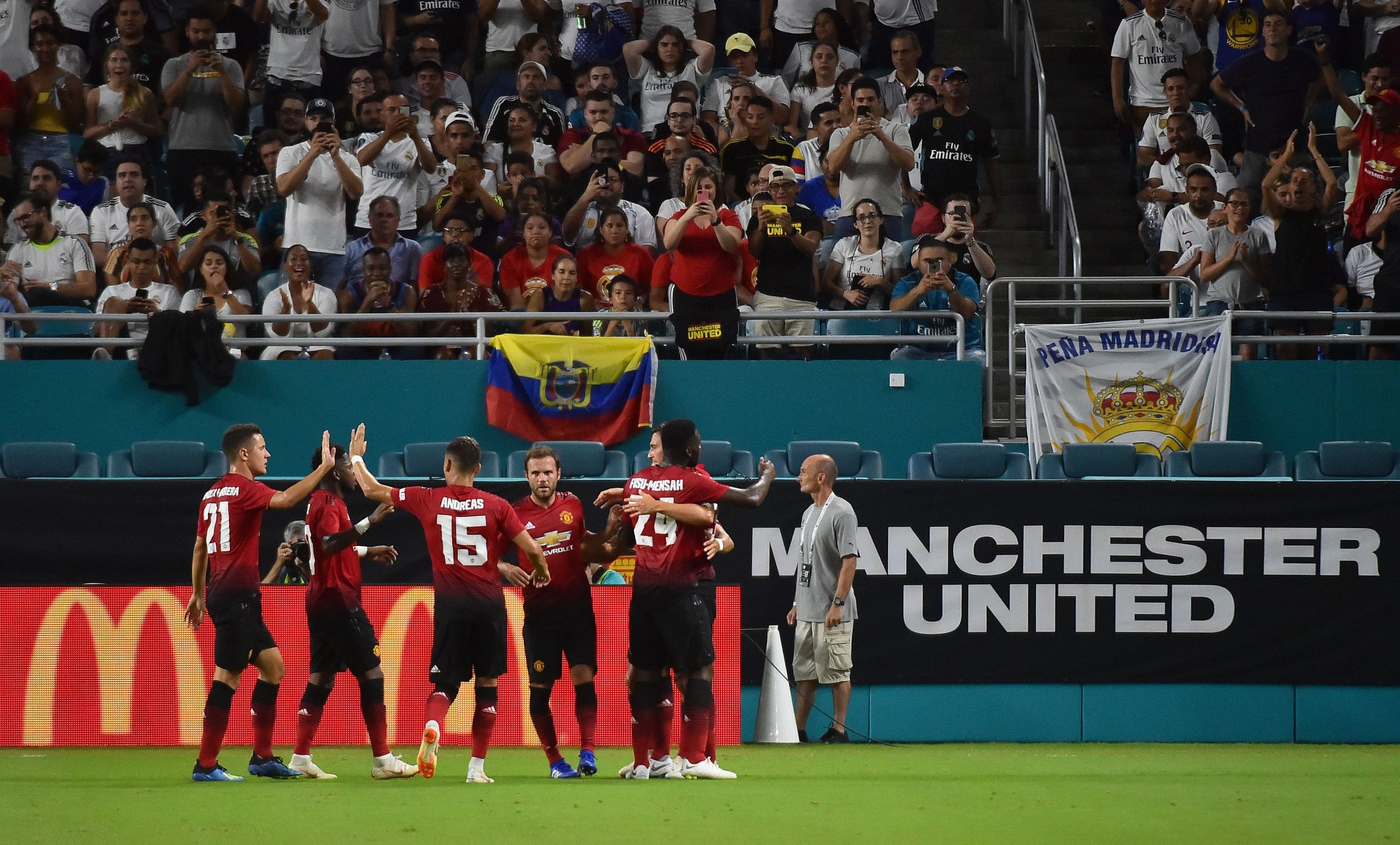 Manchester United teammates celebrate the goal of forward Alexis Sanchez (7) against Real Madrid during the first half of an International Champions Cup soccer match at Hard Rock Stadium.