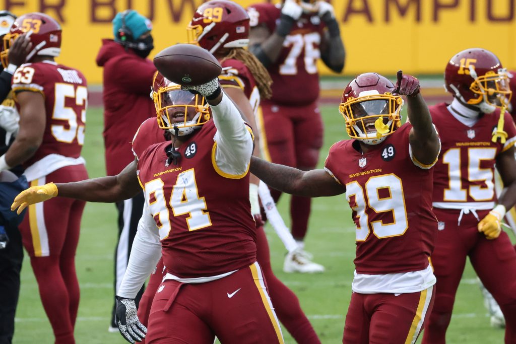 Washington Football Team nose tackle Daron Payne (94) celebrates with teammates after intercepting a pass against the Seattle Seahawks in the fourth quarter at FedExField.
