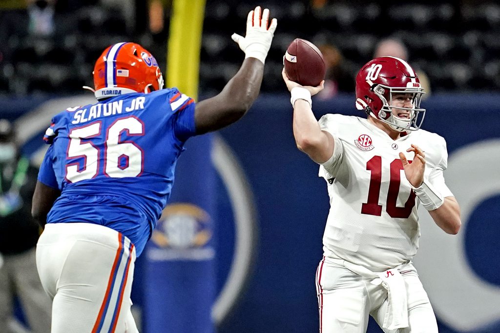 Dec 19, 2020; Atlanta, Georgia, USA; Alabama Crimson Tide quarterback Mac Jones (10) throws a pass against Florida Gators defensive lineman Tedarrell Slaton (56) during the first half in the SEC Championship at Mercedes-Benz Stadium.