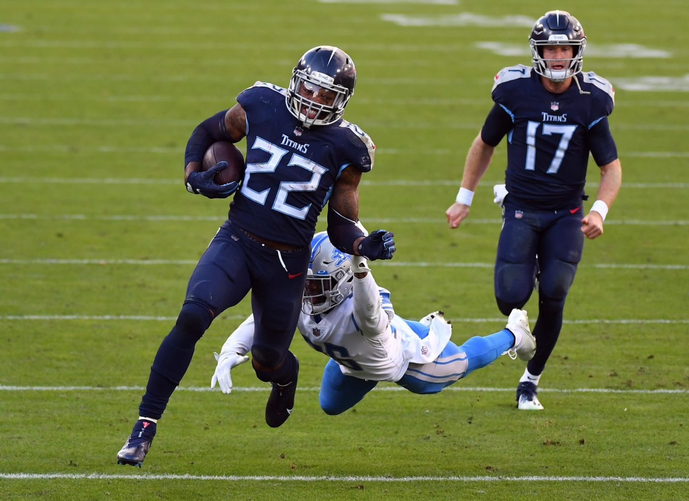 Tennessee Titans running back Derrick Henry (22) runs away from Detroit Lions strong safety Duron Harmon (26) during the second half at Nissan Stadium.