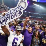 LSU Tigers head coach Ed Orgeron celebrates with his players and his wife Kelly after defeating the Oklahoma Sooners in the 2019 Peach Bowl college football playoff semifinal game at Mercedes-Benz Stadium in Atlanta, Georgia.