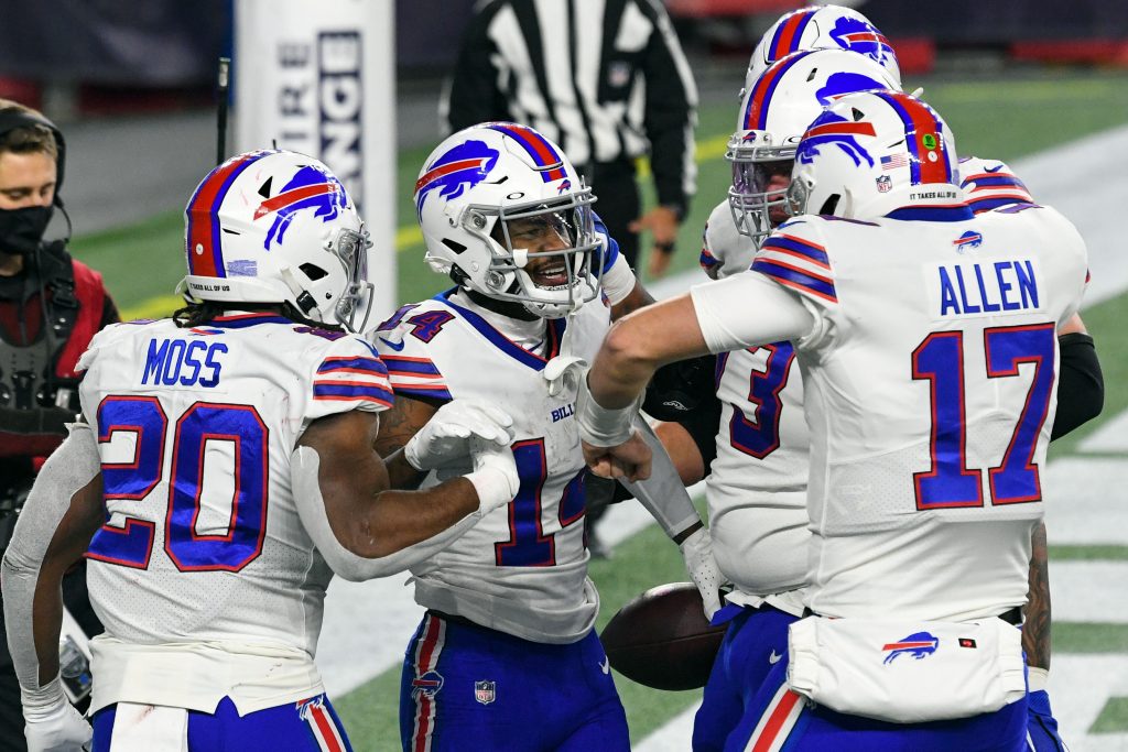 Dec 28, 2020; Foxborough, Massachusetts, USA; Buffalo Bills wide receiver Stefon Diggs (14) celebrates with quarterback Josh Allen (17) and running back Zack Moss (20) after scoring a touch down against the New England Patriots during the second half at Gillette Stadium. Mandatory Credit: Brian Fluharty-USA TODAY Sports