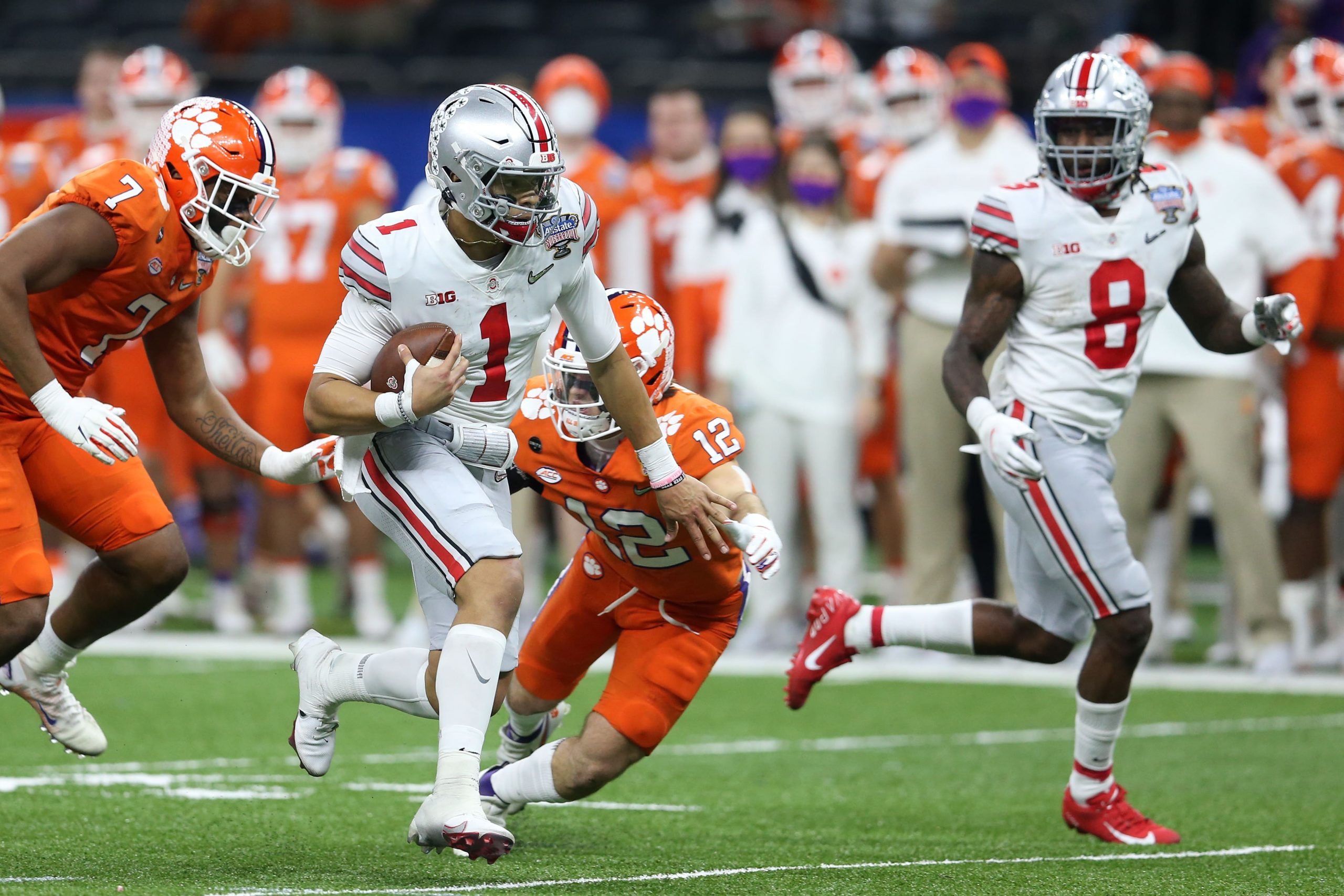 Ohio State Buckeyes quarterback Justin Fields scrambles with the ball during Sugar Bowl win over Clemson