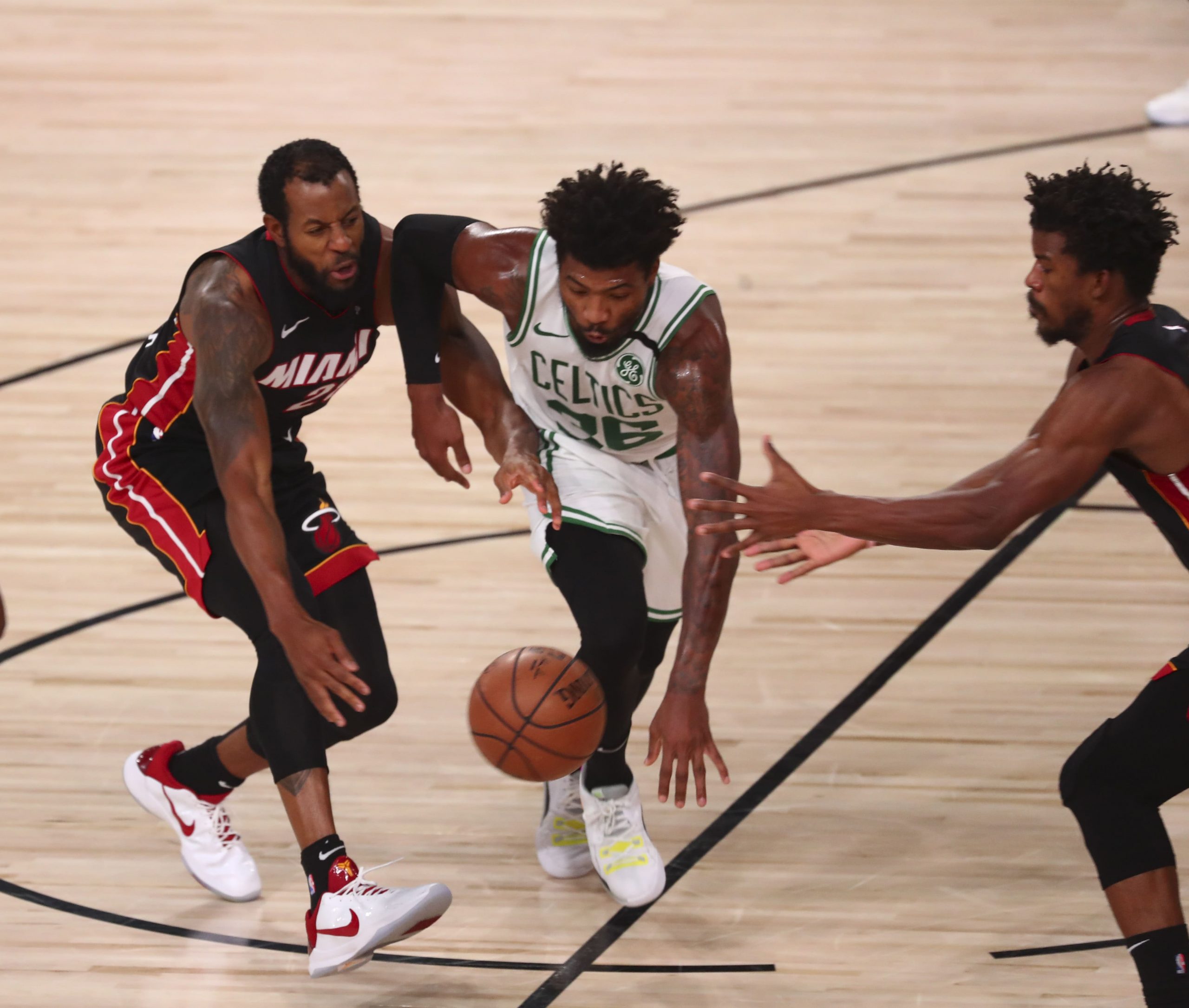 Boston Celtics guard Marcus Smart goes for loose ball against Miami Heat forwards Jimmy Butler and Andre Iguodala