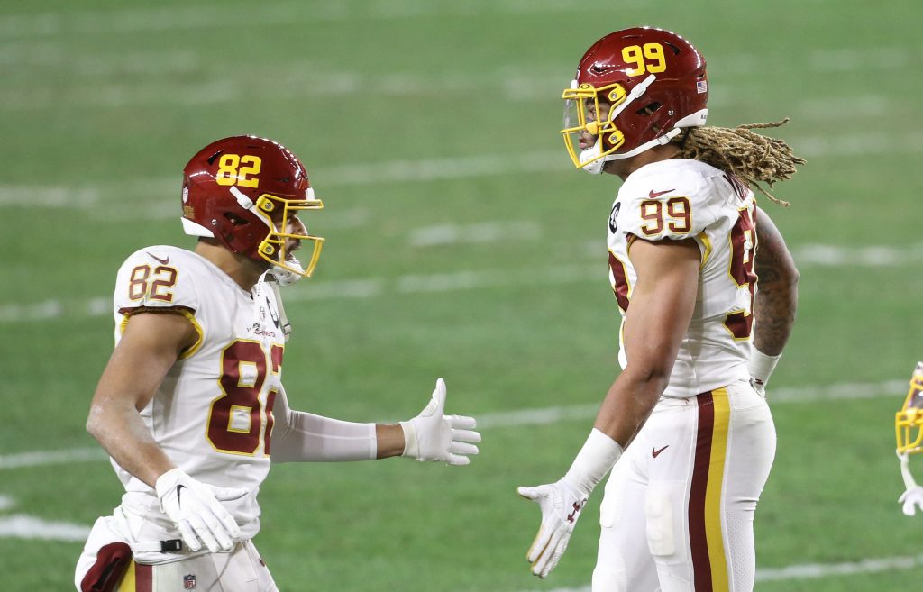 Washington Football Team tight end Logan Thomas (82) congratulates defensive end Chase Young (99) on a defensive stop against the Pittsburgh Steelers during the second quarter at Heinz Field.