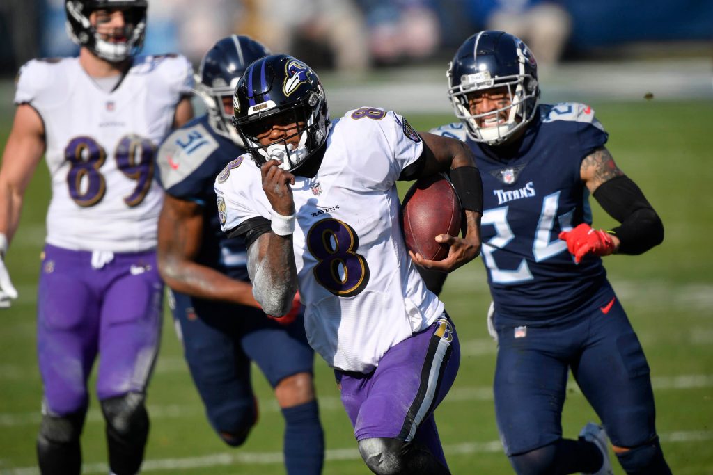 Baltimore Ravens quarterback Lamar Jackson (8) runs for a touchdown during the Tennessee Titans game against the Baltimore Ravens in Nashville on January 10, 2021.