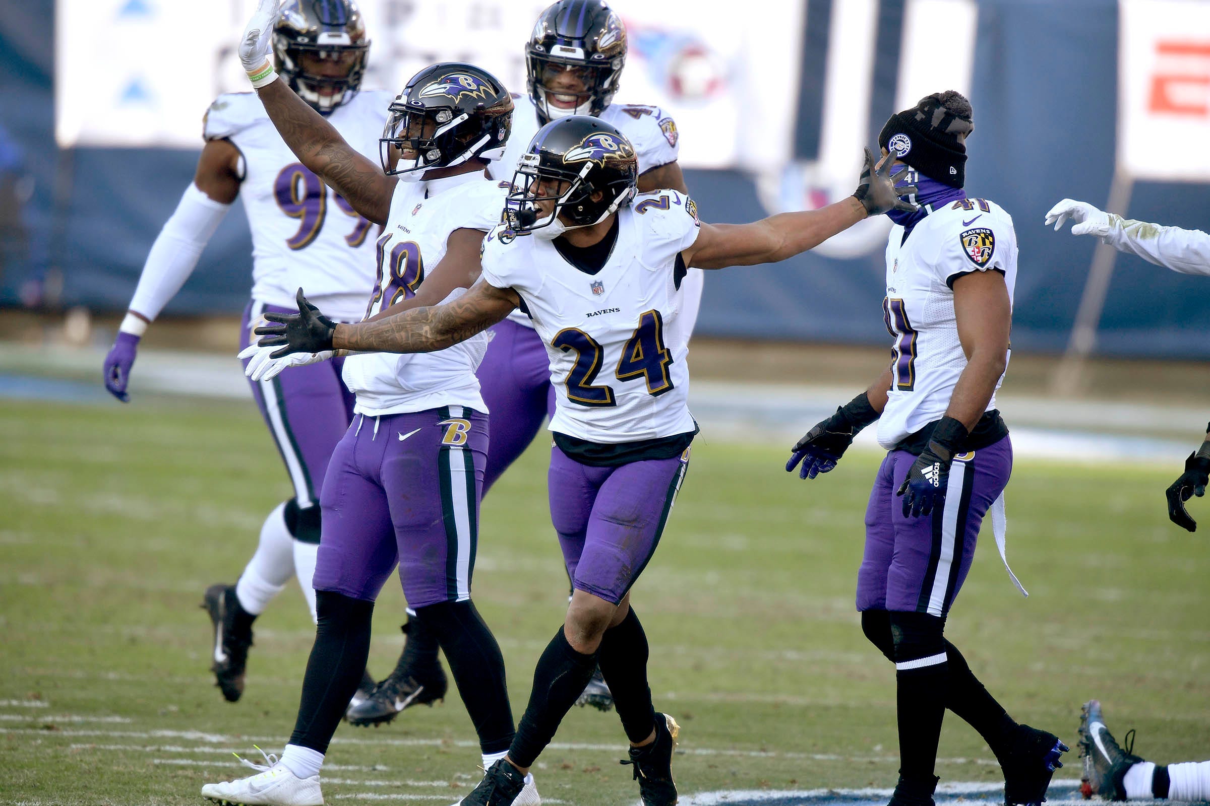 Baltimore Ravens cornerback Marcus Peters (24) and his teammates stomp on the Titans logo after Peters picked up an interception to seal their win over the Tennessee Titans in Nashville.