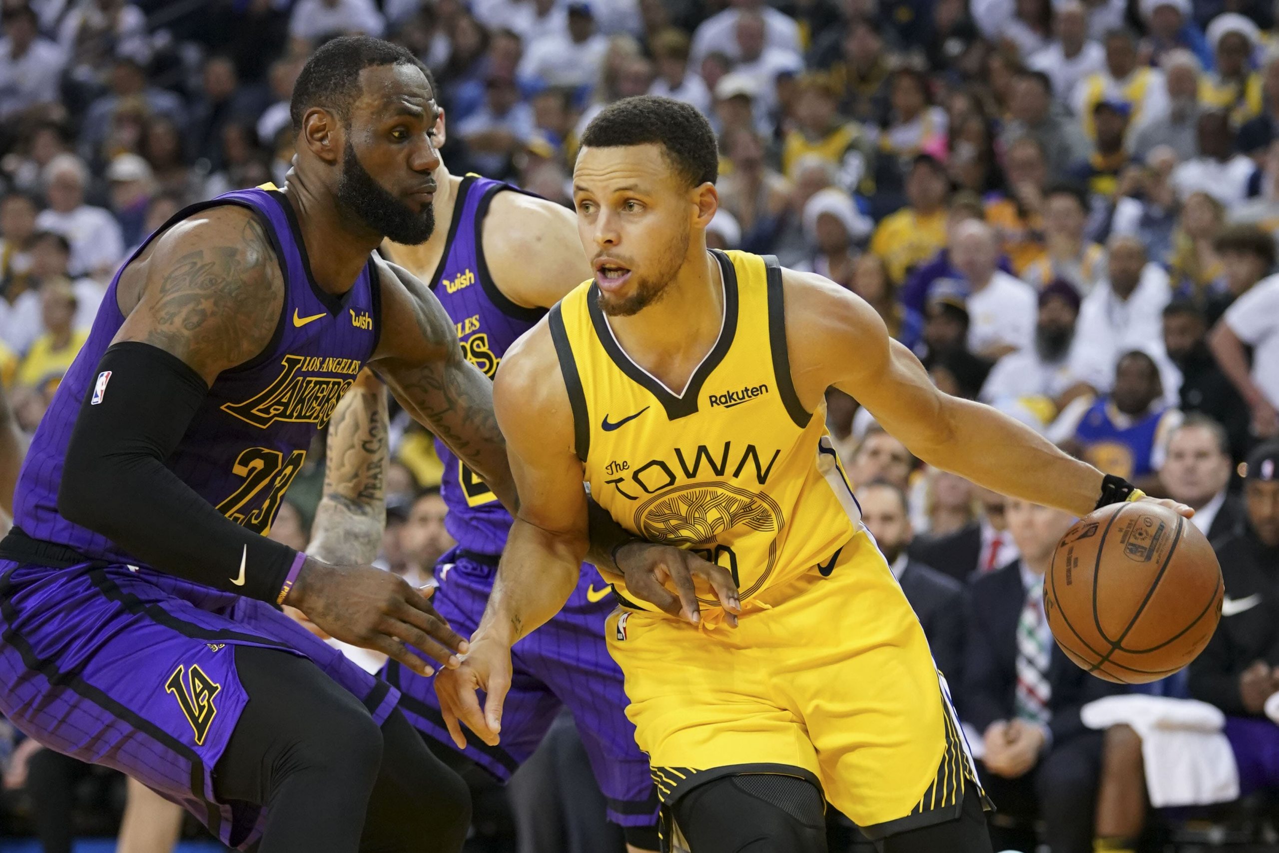 Golden State Warriors guard Stephen Curry dribbles the ball against Los Angeles Lakers forward LeBron James during Christmas 2018 game